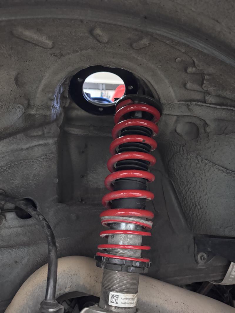 Photograph of the coilover with the OEM top-mount removed.